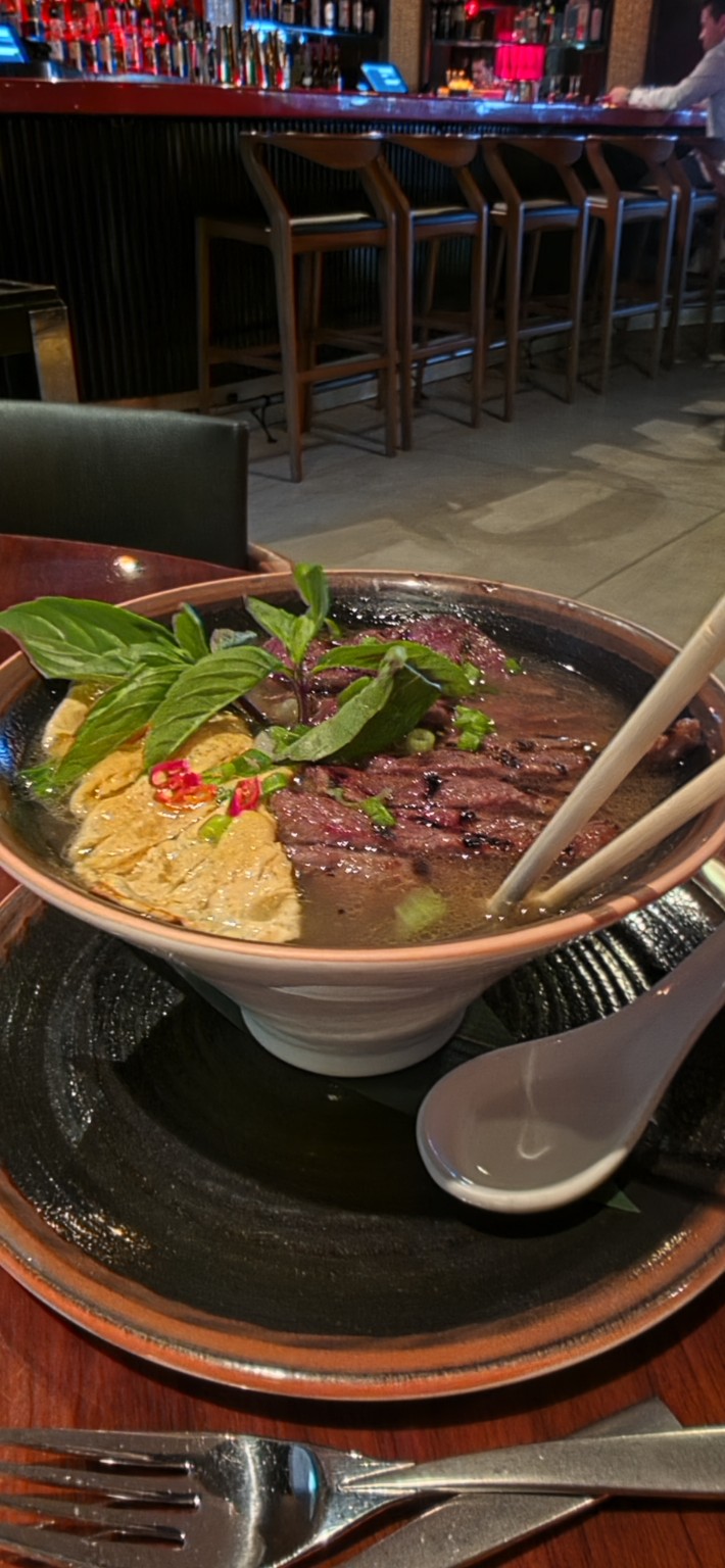 Ramen with sliced beef tenderloin, Asian greens, herbs, and ginger broth at Echo Palm Beach