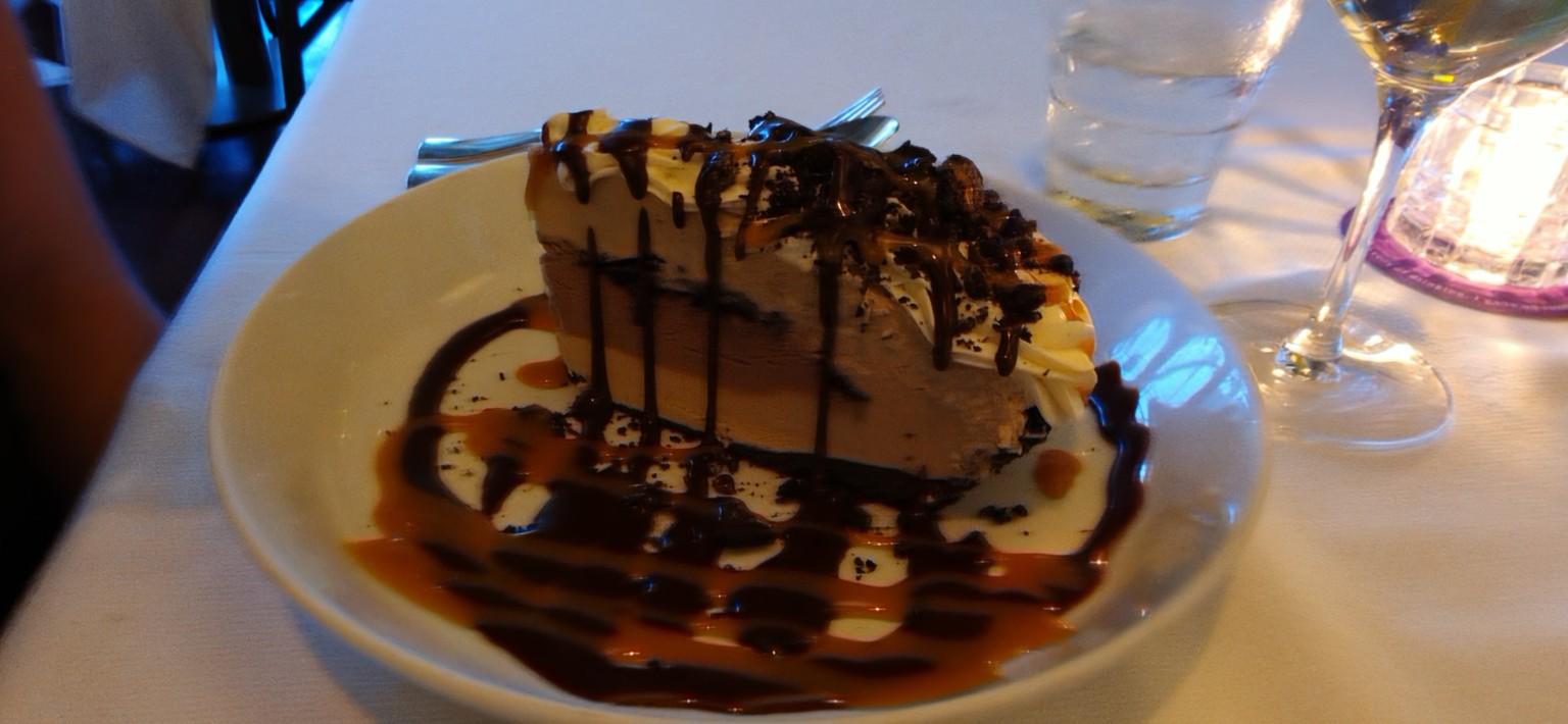 Layered Mississippi Mud Pie with chocolate and caramel sauces at Henry's Palm Beach