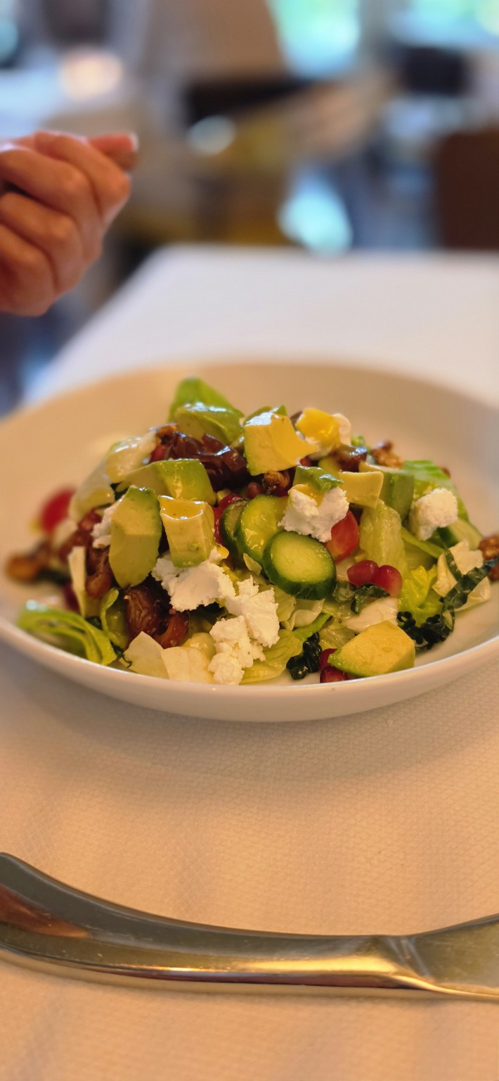 Tavern Salad with avocado, goat cheese, dates, cucumber, and greens at Henry's Palm Beach