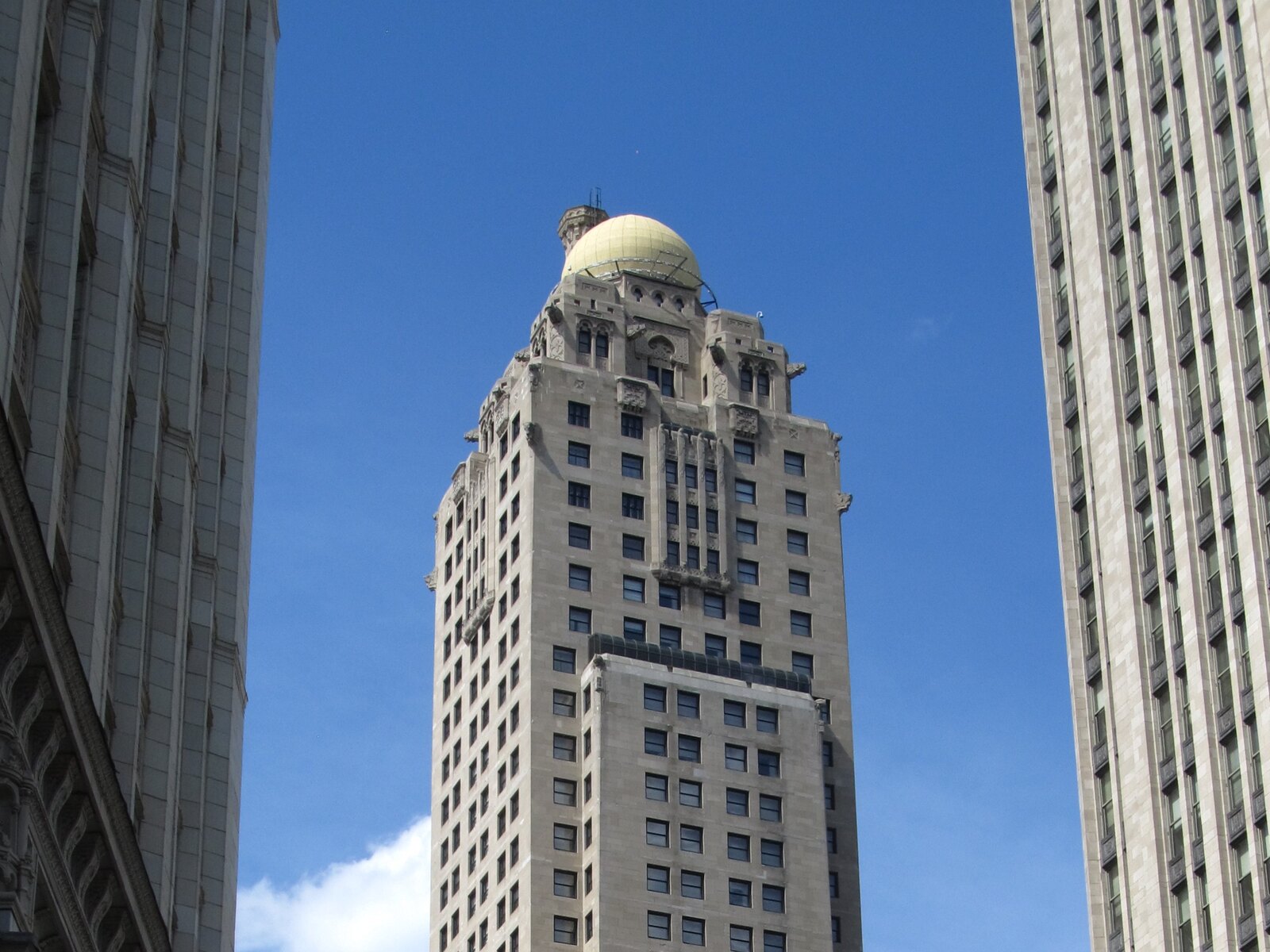 The historic tower of the InterContinental Chicago Magnificent Mile against a blue sky
